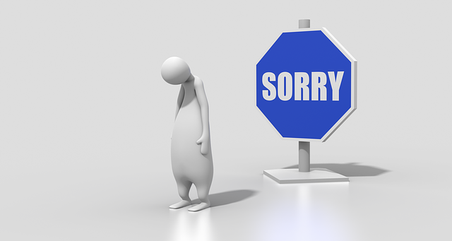 Image of cartoon man in front of sign that says sorry on article on british traditions and customs