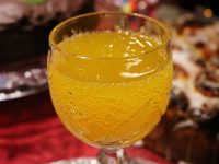 Image of orange fizzy drink in a glass in how to avoid a hangover