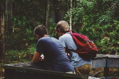 Image of male friends in the forest on how to cope with homesickness abroad