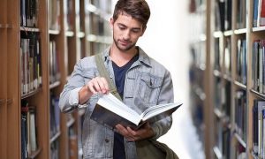 Image of man reading book on article on study abroad in london
