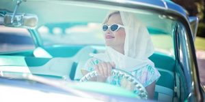Image of woman wearing vintage clothing in vintage car on small business ideas for students