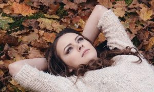 Image of woman lying outside on article on being in a relationship while studying abroad